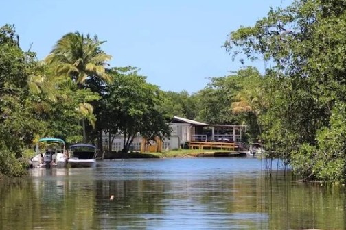 a small house surrounded by water
